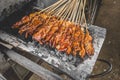Chicken satay being grilled on a traditional grill on a cart. Sate is a typical dish of Madura, Indonesia