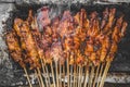 Chicken satay being grilled on a traditional grill on a cart. Sate is a typical dish of Madura, Indonesia