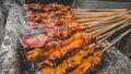 Chicken satay being grilled on a traditional grill on a cart. Sate is a typical dish of Madura, Indonesia