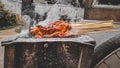 Chicken satay being grilled on a traditional grill on a cart. Sate is a typical dish of Madura, Indonesia