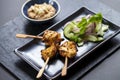 Chicken satay and cucumber salad