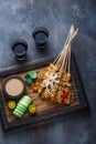 Chicken Satay or Sate Ayam - Malaysian famous food. Is a dish of seasoned, skewered and grilled meat, served with a Royalty Free Stock Photo