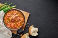 Chicken and Sausage Gumbo soup in black bowl on dark slate backdrop. Gumbo is louisiana cajun cuisine soup with roux. American USA Royalty Free Stock Photo