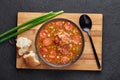 Chicken and Sausage Gumbo soup in black bowl on dark slate backdrop. Gumbo is louisiana cajun cuisine soup with roux. American USA Royalty Free Stock Photo