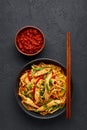 Chicken Schezwan Noodles or Hakka or Chow Mein in black bowl at dark background. Schezwan Noodles is indo-chinese cuisine hot dish