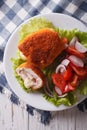 Chicken schnitzel cordon bleu and a salad close-up. vertical top Royalty Free Stock Photo