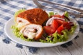 Chicken schnitzel cordon bleu and salad on a plate close-up. horizontal Royalty Free Stock Photo