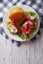 Chicken schnitzel cordon bleu and a salad. vertical top view