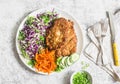 Chicken schnitzel tempura, red and white cabbage coleslaw and spicy pickled carrots on a light background, top view.