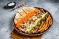 Chicken Shawarma Doner kebab on a plate with french fries, vegetables and salad. Gray background. Top view Royalty Free Stock Photo