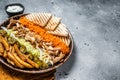 Chicken Shawarma Doner kebab on a plate with french fries, vegetables and salad. Gray background. Top view. Copy space Royalty Free Stock Photo