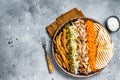 Chicken Shawarma Doner kebab on a plate with french fries, vegetables and salad. Gray background. Top view. Copy space Royalty Free Stock Photo