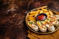 Chicken shawarma durum doner kebab with vegetable salad and french fries. Dark background. Top view. Copy space Royalty Free Stock Photo