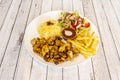 Chicken shawarma plate with pilau rice, potatoes fries and turkish salad Royalty Free Stock Photo