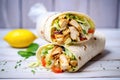 chicken shawarma wrap cut in half, showing the filling