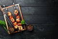 Chicken shish kebab with onions and tomatoes. Barbecue. On a black background. Top view. Royalty Free Stock Photo