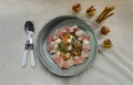 Chicken and Shrimp Fusilli with Cheese, Sausage and Bread in Ceramic plate served with Bread sticks and Cutlery set on white