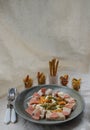 Chicken and Shrimp Fusilli with Cheese, Sausage and Bread in Ceramic plate served with Bread sticks and Cutlery set on white