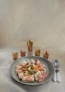 Chicken and Shrimp Fusilli with Cheese, Sausage and Bread in Ceramic plate served with Bread sticks and Cutlery set on white