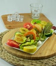 Chicken skewer on porcelain plate and garnish next to glass with ice