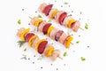 Raw chicken meat skewers with vegetables,plums,yellow pepper,onions,with spices,herbs white background.Top view.Chicken Royalty Free Stock Photo