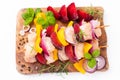 Raw chicken meat skewers with vegetables,plums,yellow pepper,onions,with spices,herbs white background.Top view.Chicken Royalty Free Stock Photo