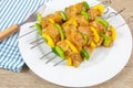 Chicken skewers and raw peppers, marinated in curry