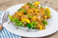 Chicken skewers and raw peppers, marinated in curry