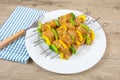 Chicken skewers and raw peppers, marinated in curry