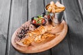 Chicken skewers with sauce and potatoes fries in a bucket on wooden cutting board. Royalty Free Stock Photo