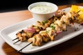 chicken skewers served with a side of garlic aioli