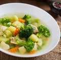 Chicken soup with broccoli, green peas, carrots and celery in a Royalty Free Stock Photo