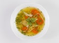 Chicken soup or broth with noodels, chicken meat pieces , carrot slices and herbs Royalty Free Stock Photo