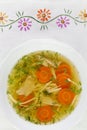 Chicken soup or broth with noodels, chicken meat pieces , carrot slices and herbs Royalty Free Stock Photo