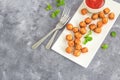 Crispy Chicken Popcorn with Tomato Ketchup, Garnished with Mint Leaves, Top Down, Flat Lay Photo on Dark Background