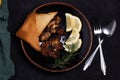 Chicken Steak with Black Pepper Garnish with Lemon and Rosemary. Dark Tone Royalty Free Stock Photo