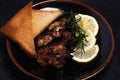 Chicken Steak with Black Pepper Garnish with Lemon and Rosemary. Dark Tone Royalty Free Stock Photo