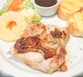 Chicken steak served with butter bread, Pineapple slices, lettuce, carrot and sauce