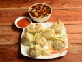 Chicken steam momo and chicken soup, Nepalese Traditional dish Momo stuffed with chicken and then cooked and served over a rustic