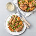 Chicken stew with potatoes, mushrooms and green peas, on a white plate and in a metal pot, top view, square Royalty Free Stock Photo