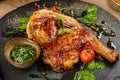 Chicken Tabaka with sauce on stone plate. Royalty Free Stock Photo
