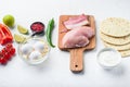 Chicken tacos organic raw ingredients , tomatoes, corn, egg, pepper,lime chicken meat and tortillas over white textured background Royalty Free Stock Photo