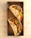 Chicken tacos with peppers and onions on copper tray Royalty Free Stock Photo