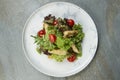 Chicken Tempura Salad on white marble plate, stone anthracite background Royalty Free Stock Photo