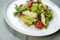Chicken Tempura Salad on white marble plate, stone anthracite background Royalty Free Stock Photo