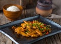 CHICKEN TEPPANYAKI served in a dish isolated on wooden background side view of Teppanyaki