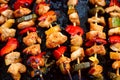 Chicken teriyaki kebabs with vegetables on black baking