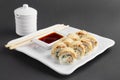 Chicken teriyaki roll with chopsticks and soy sauce