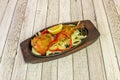 Chicken thigh cooked in Indian tandoori style with vegetables and on hot metal plate