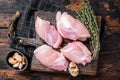 Chicken thigh fillet, Raw Boneless and skinless meat on a cutting board. Wooden background. Top view